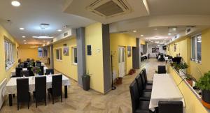 a dining room with tables and chairs and yellow walls at Mirocki-Raj in Miroč