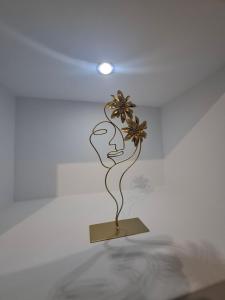 a statue of a woman holding a flower on a shelf at Hanna's Villagio in Korinthos