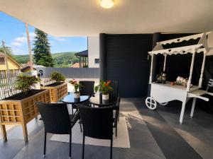 a patio with a table and chairs and a cart at Luxury Villa Vienna in Mauerbach