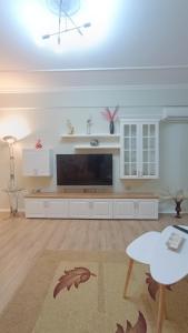 a large living room with a flat screen tv at Arthouse Elbasan in Elbasan