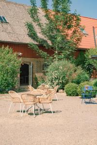 a group of chairs and tables in front of a building at Tunnby Gårdshotell in Nyhamnsläge