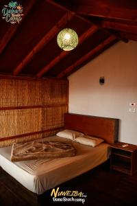a bedroom with a large bed with a chandelier at Dana beach camp in Nuweiba