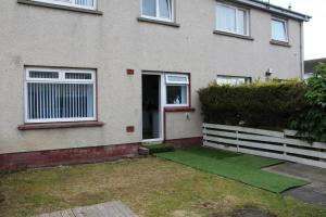 a house with a green lawn in front of it at wyvis stays in Inverness