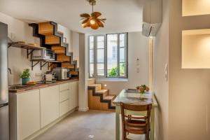 a kitchen with a staircase and a table in a room at Casa Campinchi in Bastia