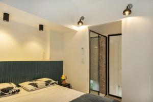 a bedroom with a bed with a green headboard at Casa Campinchi in Bastia