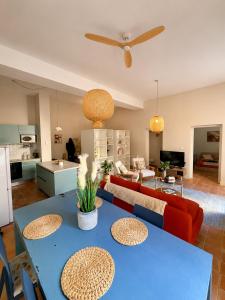 a living room with a blue table and a couch at T2 monument historique Aix en provence in Aix-en-Provence