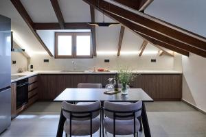 a kitchen with a table and chairs in a kitchen at Villa Rock&SeaView in Livanates