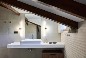 a bathroom with a white sink and a mirror at Villa Rock&SeaView in Livanates +61 photos