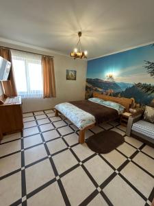 a bedroom with a bed and a painting on the wall at Villa OkSun in Skhidnitsa +90 photos