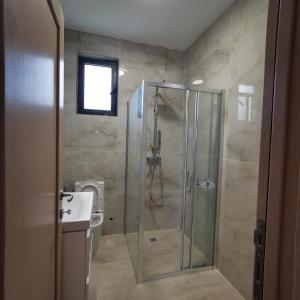 a bathroom with a shower and a toilet and a sink at Visnjeva Gardens in Višnjevo +19 photos
