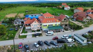 a large house with cars parked in a parking lot at Mirocki-Raj in Miroč