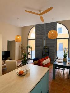 a kitchen and living room with two pendant lights at T2 monument historique Aix en provence in Aix-en-Provence