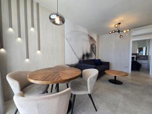 a living room with a table and chairs and a couch at Nautico apartment with swimming pool in Opatija