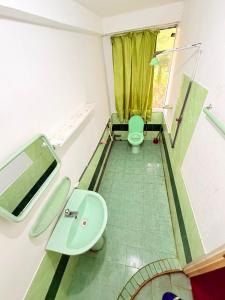 a bathroom with a toilet and a sink at Coca Cola Hostel Malabe in Malabe