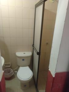 a bathroom with a toilet and a shower stall at Habitación Doble, Baño Privado, 4 Cuadras Del Rodadero, Zonas Comerciales in Gaira