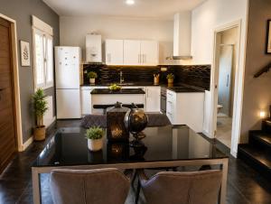 a kitchen with a table and chairs in a room at Casa de campo en alava in Ollávarre