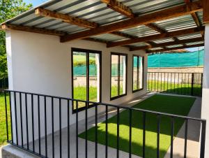 a patio with a pergola and green grass at Casa de campo en alava in Ollávarre