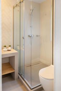 a glass shower stall in a bathroom with a toilet at Hotel Anina in Techirghiol