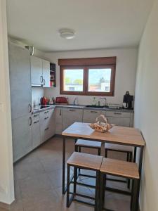 a kitchen with a table and chairs in it at Apartment Einliegerwohnung in Hagenthal-le-Haut