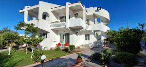 a white building with a lot of windows at Villa Maroula in Afantou