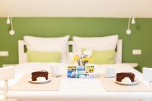 a table with two slices of chocolate cake and flowers at B&B Gösselsdorfer Seeblick in Sittersdorf +37 photos