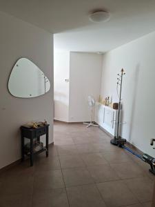 a room with a mirror on the wall and a table at Apartment Einliegerwohnung in Hagenthal-le-Haut