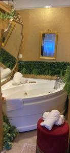 a bathroom with a white tub and a mirror at Visconti suite and spa in Catania