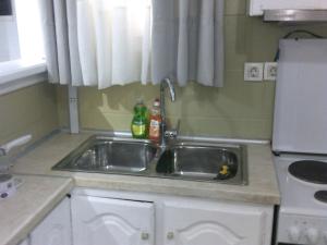 a kitchen with a sink in a kitchen at ΑΚ City Apartment 1 in Ágios Rókkos +33 photos