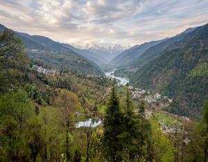 a view of a valley with a river and mountains at The Chapter Stay - Kedarnath in Phata
