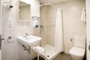a bathroom with a sink and a shower and a toilet at L´Hostalet in Tossa de Mar
