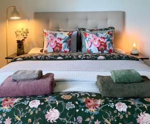 a bedroom with a large bed with colorful pillows at One More Night in Jyväskylä