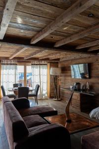a living room with a couch and a table at Hotel Etrier in Crans-Montana