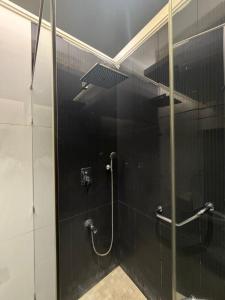 a bathroom with a shower with a glass door at Studio in South Khobar in Al Khobar +1 photo
