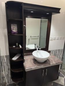 a bathroom with a sink and a mirror at Studio in South Khobar in Al Khobar