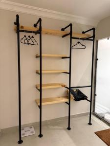 a shelf in a room with wooden shelves at Studio in South Khobar in Al Khobar