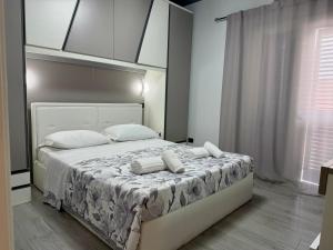 a bedroom with a large bed with white sheets and pillows at Luxury Sofi in Giardini Naxos