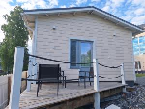 a house with two chairs on a wooden deck at Apartment Songhill in Kuopio