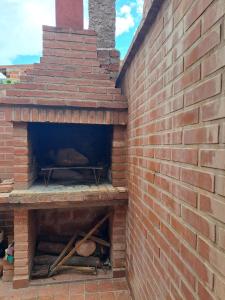 a brick oven with a pizza inside of it at SumayWasi in Tilcara