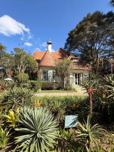 a house with a lot of plants in front of it at Granja Brasil , Studio Itaipava in Araras Petropolis