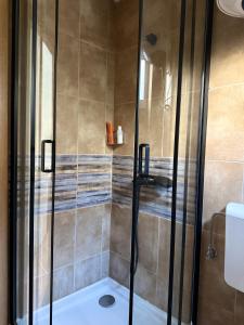 a shower with a glass door in a bathroom at Splendid corner in Bečići +3 photos
