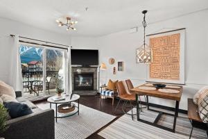 a living room with a couch and a table at Stunning Mountain Views - Pool&HotTub - King Bed - BBQ in Canmore