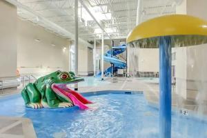 a frog on a water slide in a pool at Stunning Mountain Views - Pool&HotTub - King Bed - BBQ in Canmore