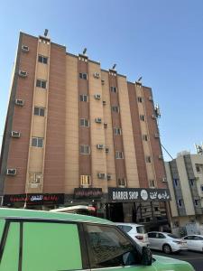 a large building with cars parked in front of it at رحيانه ابها in Abha