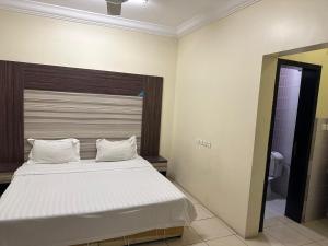 a bedroom with a large bed with white sheets at رحيانه ابها in Abha +7 photos