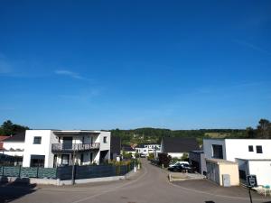 arial view of a town with white houses and a street at Apartment Einliegerwohnung in Hagenthal-le-Haut
