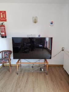 a living room with a large tv on a wall at Miramar Viladecans in Viladecáns