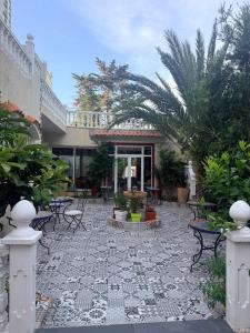 a patio with chairs and plants and a building at Malabata Guest House in Tangier
