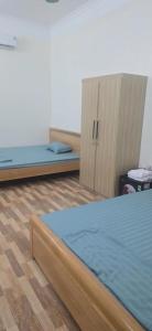 a room with two beds and two cabinets at Cô tô xinh in Quang Ninh
