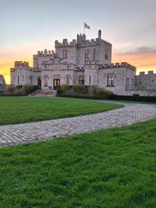 a castle with a green lawn in front of it at GITE 2 LE GRAND CHENE in Condette
