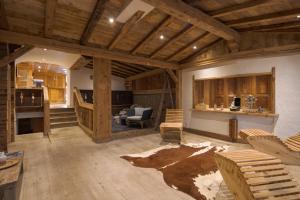 a large living room with wooden walls and wooden ceilings at Hotel Etrier in Crans-Montana